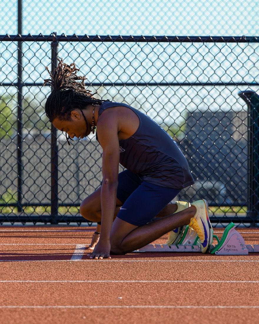Sprinter in the starting blocks at golden hour